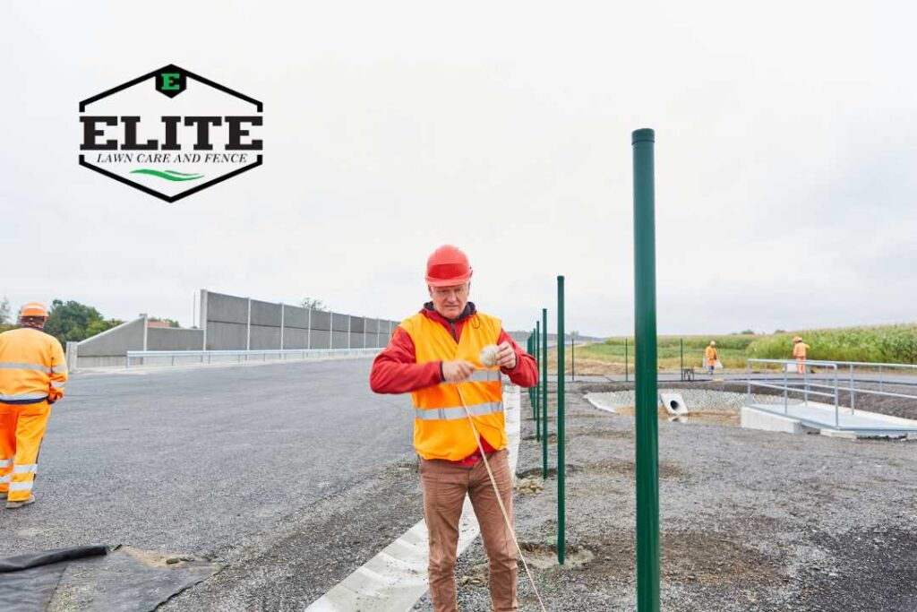 fence contractor installing a fence for construction